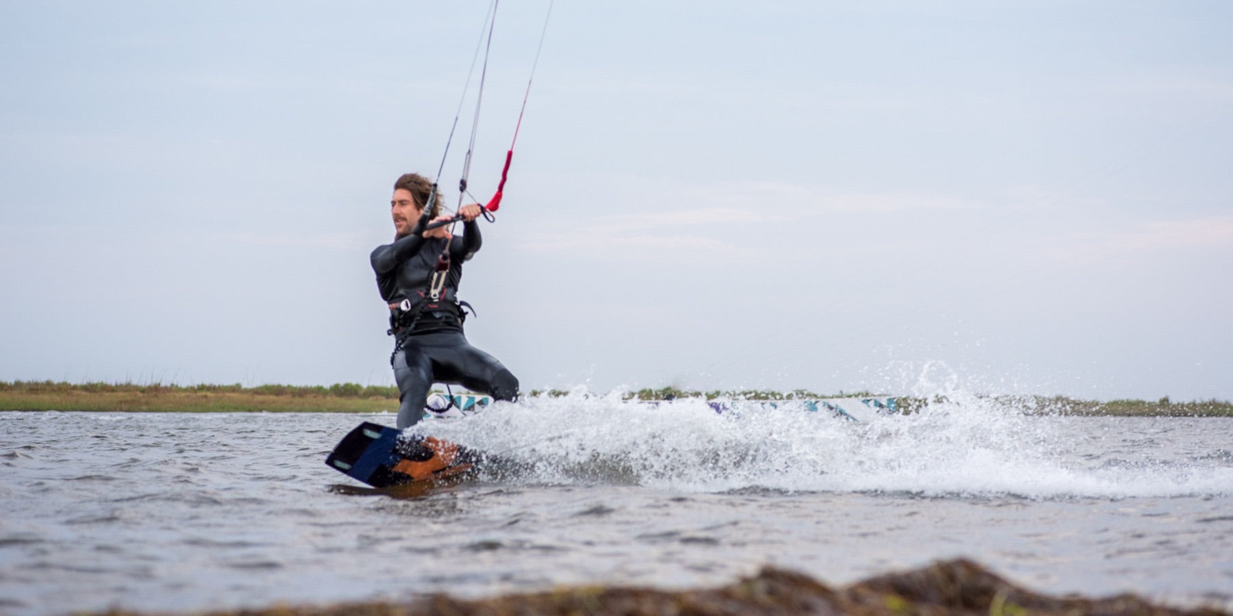 A kiteboarding riding through the flat waters of the Pamlico Sound in Avon North Carolina. 